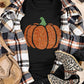 Black short-sleeve t-shirt with a glitter pumpkin design, styled with a plaid shirt.