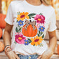 White round neck t-shirt with a pumpkin and floral graphic.