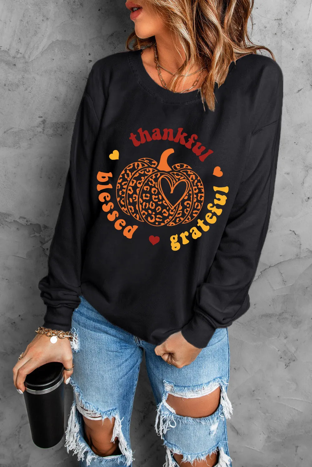 Black long sleeve sweatshirt with a pumpkin graphic and "thankful blessed grateful" text.