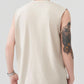 Rear view of a man wearing a beige sleeveless tank top and black pants.