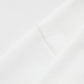Close-up of a white fabric, possibly a hoodie, showing a seam.