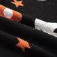 Black long-sleeve sweater with white crescent moons and orange stars.