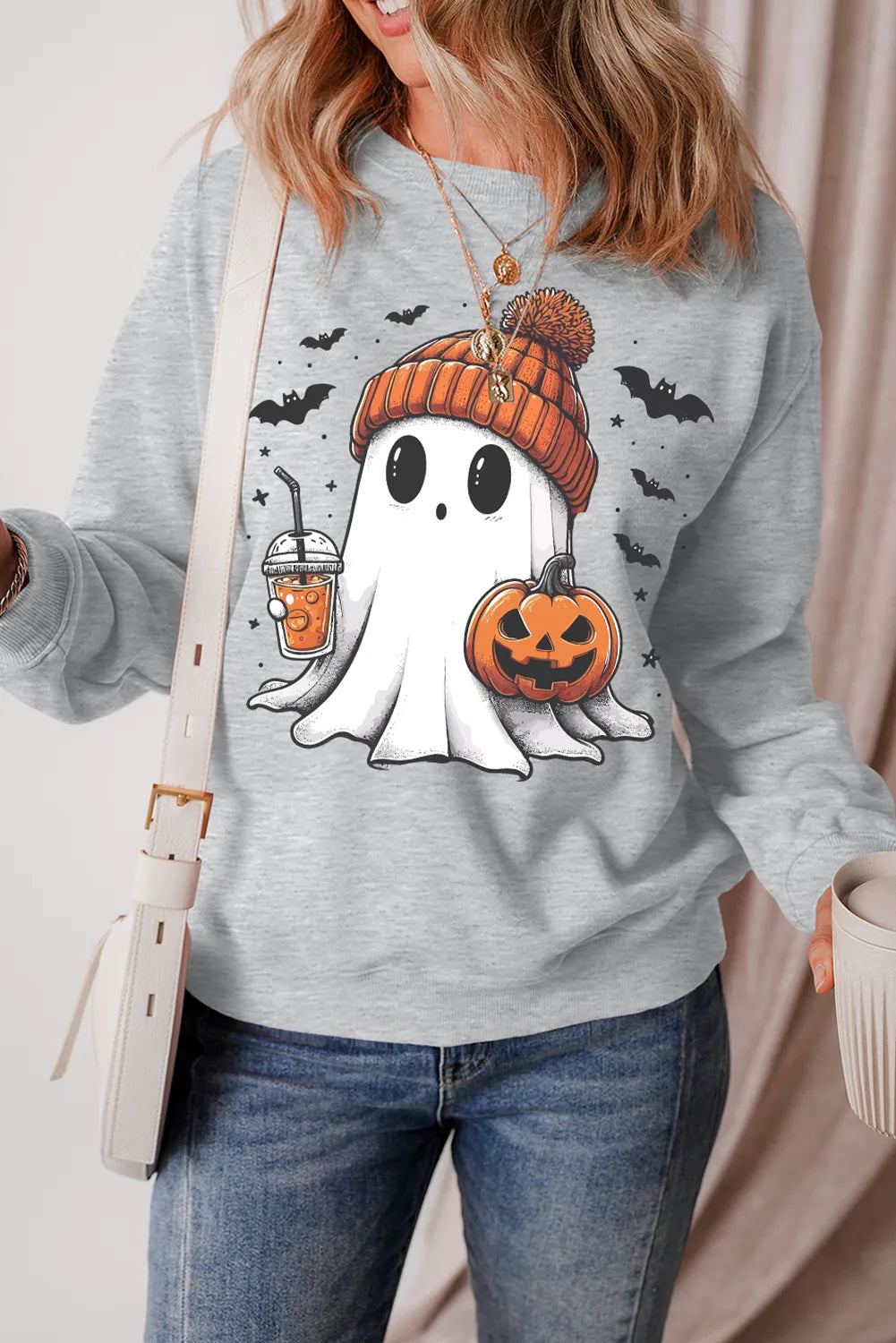 Ghost Round Neck Long Sleeve Sweatshirt with a ghost wearing a beanie and holding a pumpkin.
