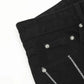 Black men's jeans with silver chains and rivets.
