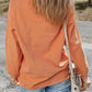 Pumpkin round neck long sleeve sweatshirt with corduroy texture.