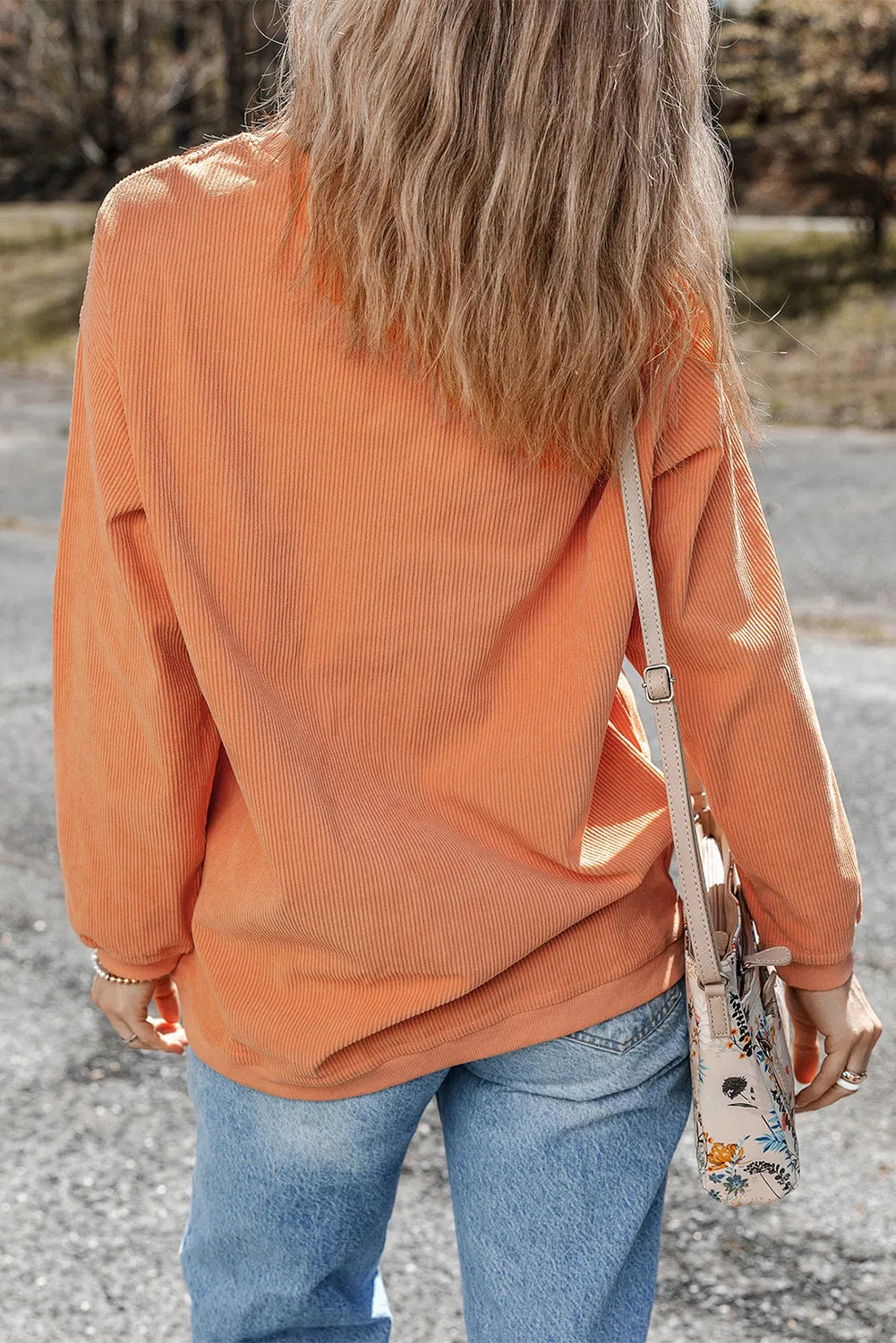 Pumpkin round neck long sleeve sweatshirt with corduroy texture.