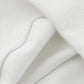 A close-up of the white ribbed and smooth fabric of the hoodie.