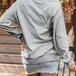 A blonde woman from behind wears a gray Halloween spooky ghost sequin sweatshirt.