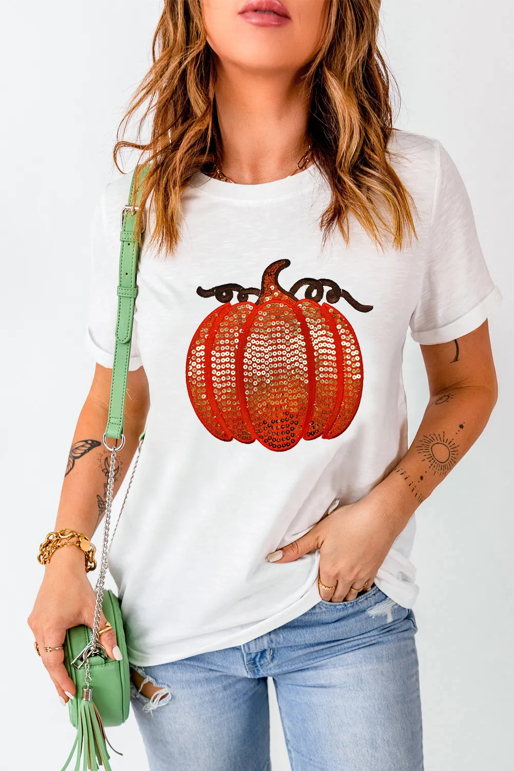 White short sleeve t-shirt with a sequin pumpkin design.