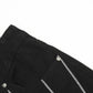 Close-up of black jeans with silver chain details and a front pocket.
