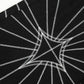 Black jeans with white spider web embroidery.
