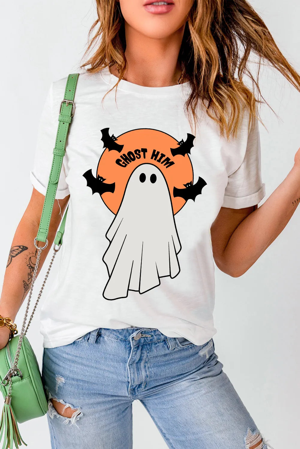 A woman wears a white t-shirt with a ghost and "GHOST HIM" graphic.