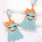 Smiling ghost shape synthetic pearl earrings with orange bows and blue beads.