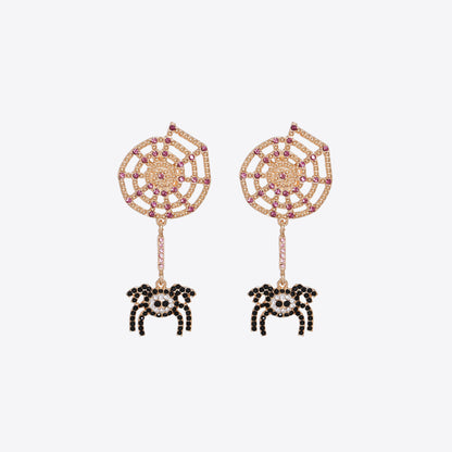 Gold-tone spiderweb earrings with pink and black rhinestones and dangling spiders.