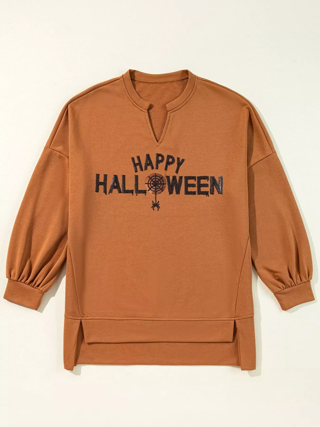 A brown long-sleeve top with a notched neckline and "Happy Halloween" graphic.