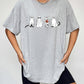 Gray short-sleeve t-shirt with a ghost cat graphic, worn by a person in black shorts.