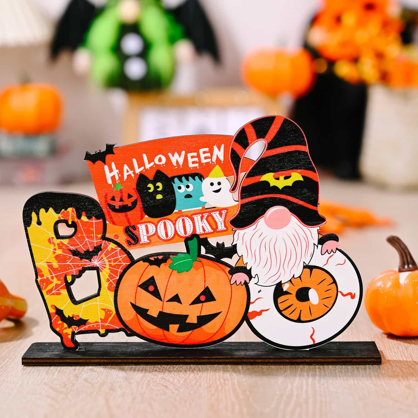 A Halloween-themed wooden ornament featuring a gnome, pumpkin, and "Spooky Halloween" text.