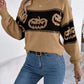 A woman wears a pumpkin round neck long sleeve sweater with blue jeans.