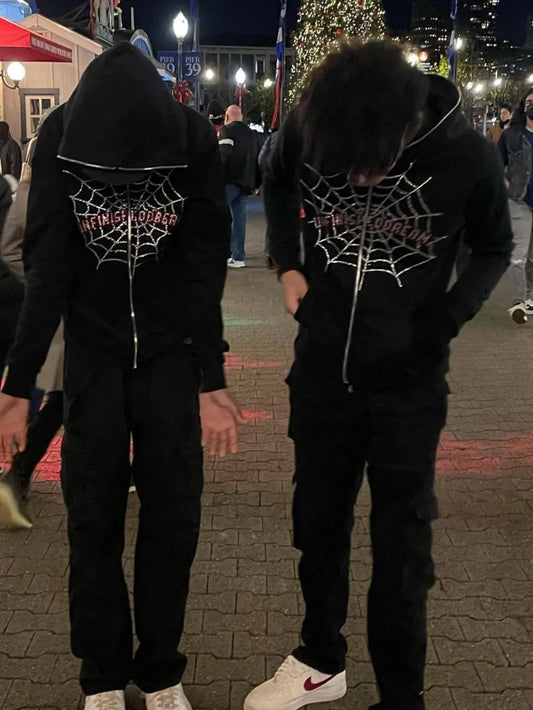 Men's black zip-up hoodie with a spider web rhinestone design.