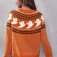 A woman from behind wears an orange round neck long sleeve sweater with a ghost pattern.