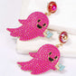 Pink ghost-shaped dangle earrings with synthetic pearls and a small blue book.