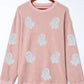 Pink ribbed oversized sweatshirt with glitter ghost patterns.