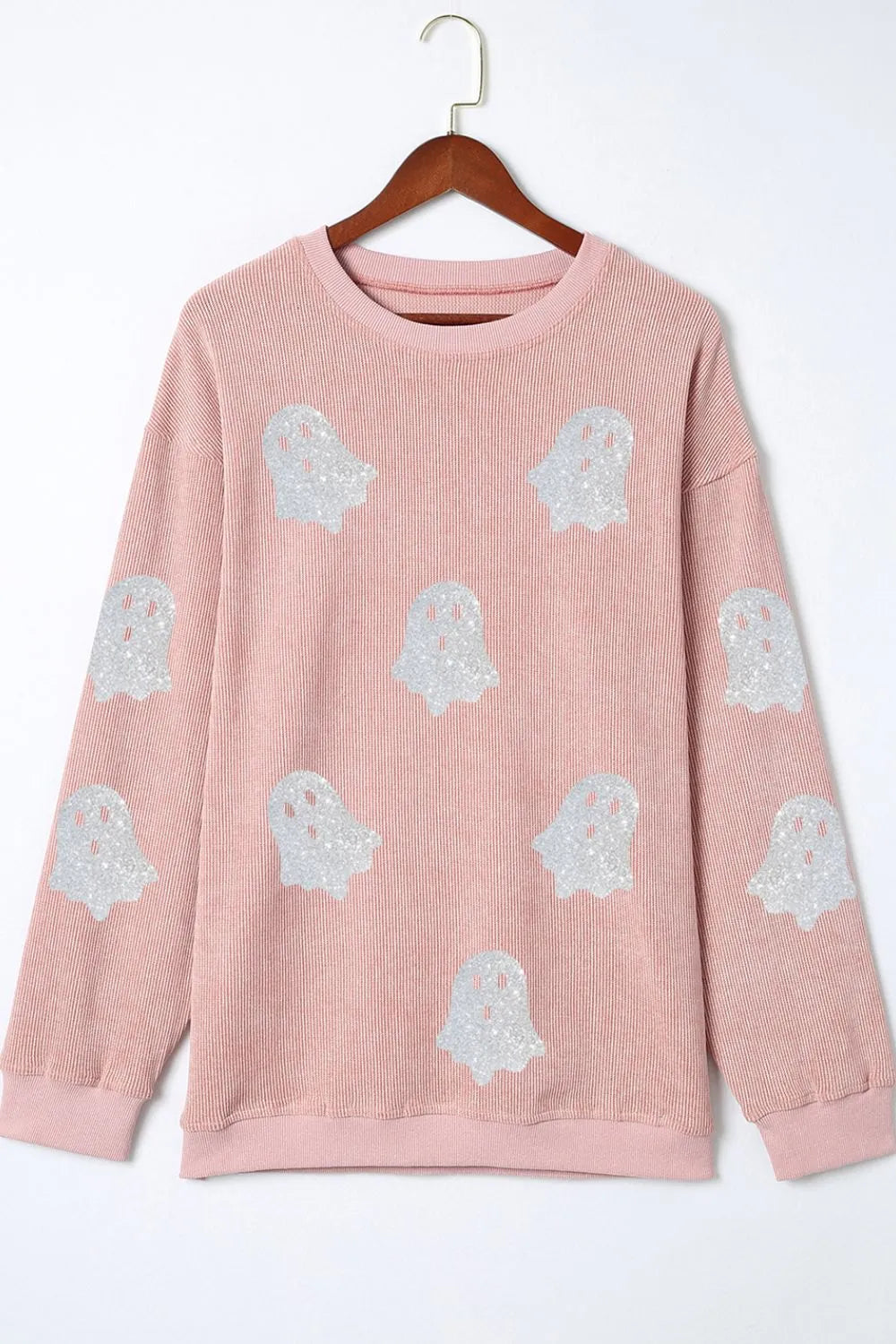 Pink ribbed oversized sweatshirt with glitter ghost patterns.