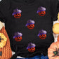 Black short-sleeve t-shirt with sequin pumpkin designs.