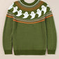 A green long-sleeve sweater with a round neck and a ghost pattern.