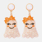 Smiling ghost shape synthetic pearl earrings with orange bows.