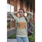 A woman wears a light green "Witch Way to the Candy?" Halloween sweatshirt.