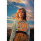 A woman wears a light gray "Witch Way to the Candy" Halloween sweatshirt.