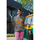 A woman wears a dark gray sweatshirt with "Witch Way to the Candy?" in orange text.