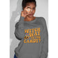 A woman wears a grey "Witch Way to the Candy?" Halloween sweatshirt.