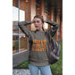 A woman wears a dark gray sweatshirt with "Witch Way to the Candy?" in orange text.