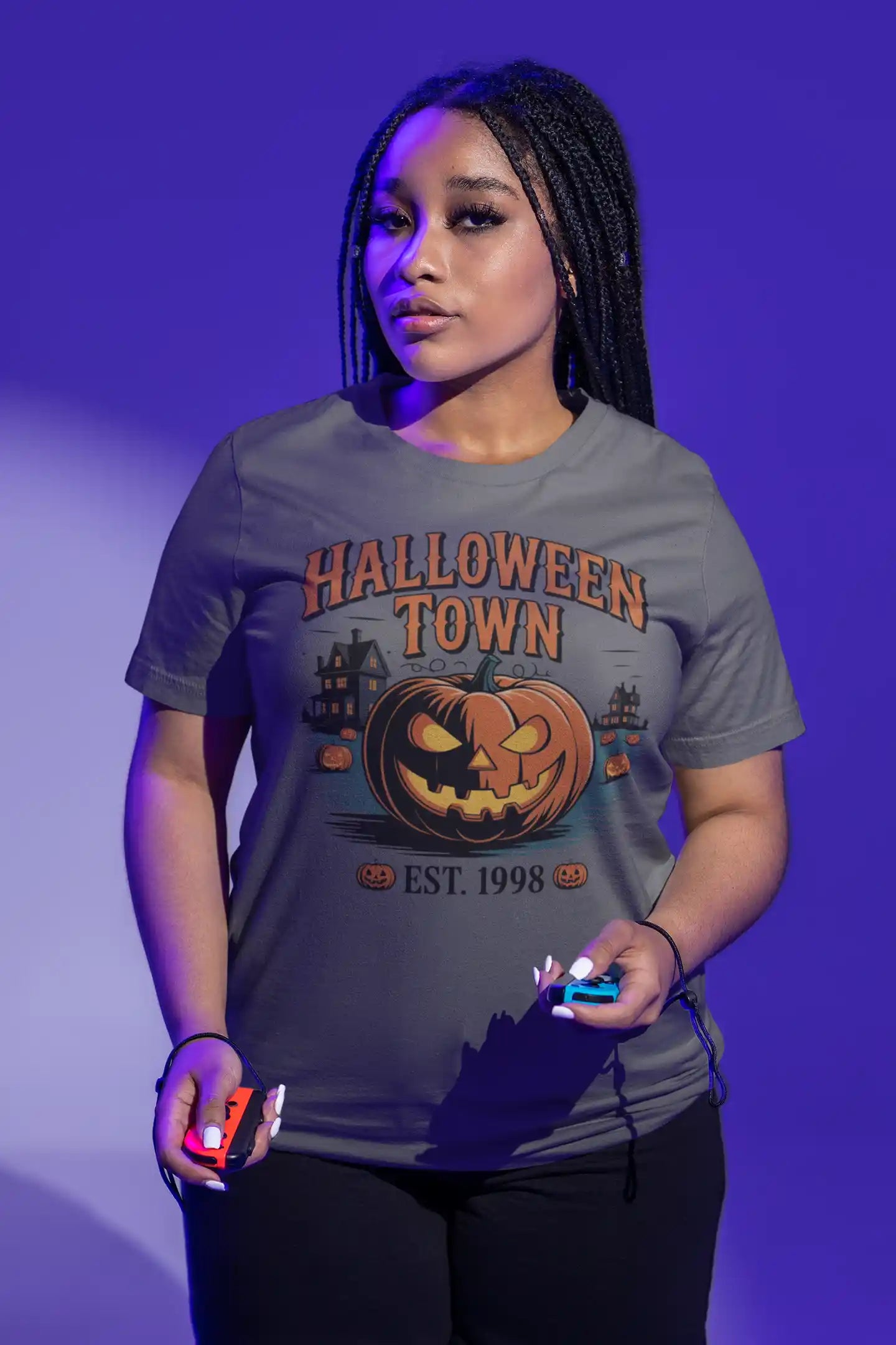 A woman wears a gray Halloween Town t-shirt with a vintage pumpkin graphic.