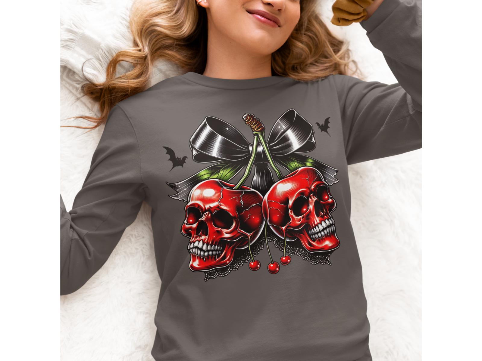 A woman wears a gray long-sleeve shirt with a spooky cherry and bow design.