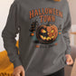 A woman wears a dark gray Halloween Town sweatshirt with a vintage pumpkin graphic.