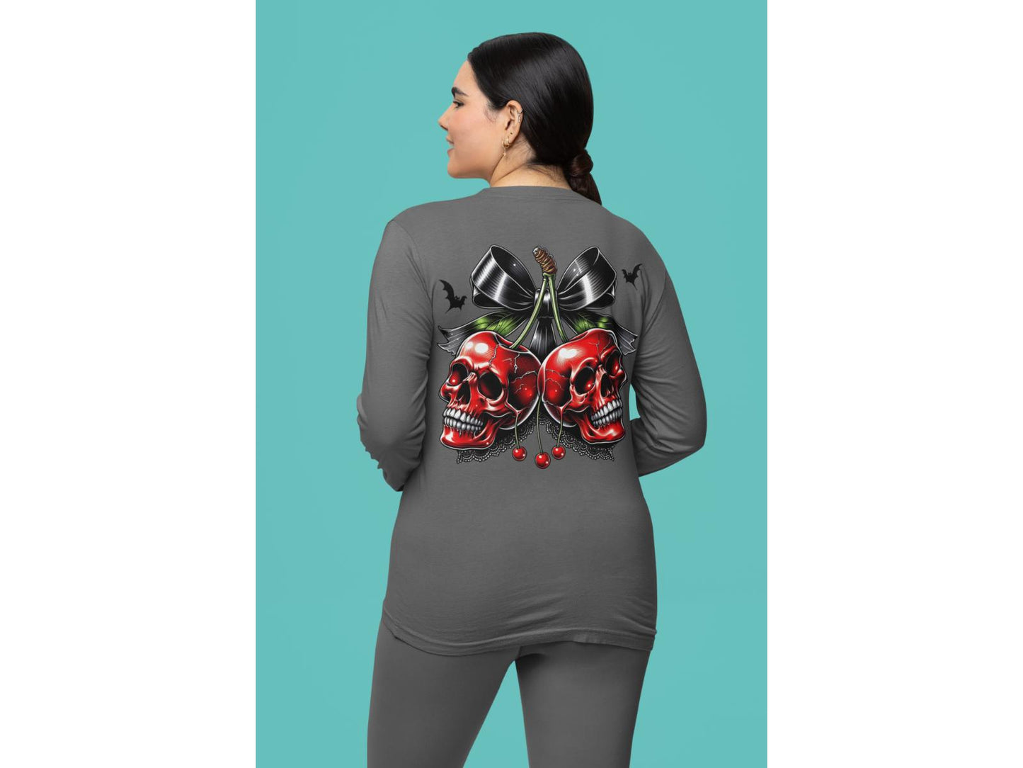 A woman from behind wears a gray long-sleeve shirt with a spooky cherry and bow design.
