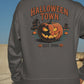 A person from behind wears a dark gray Halloween Town sweatshirt with a pumpkin graphic.