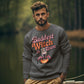 A man wears a dark gray sweatshirt with "Baddest Witch in Town" and a witch graphic.
