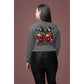 A woman from behind wears a gray long-sleeve shirt with a spooky cherry design.