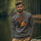 A man wears a dark gray Halloween Town sweatshirt with a pumpkin graphic.