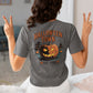 A person from behind wears a gray Halloween Town t-shirt with a pumpkin graphic.