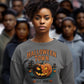 A woman wears a gray Halloween Town sweatshirt with a vintage pumpkin graphic.