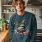 A man wears a dark teal sweatshirt with a "Happy Halloween" cauldron design.