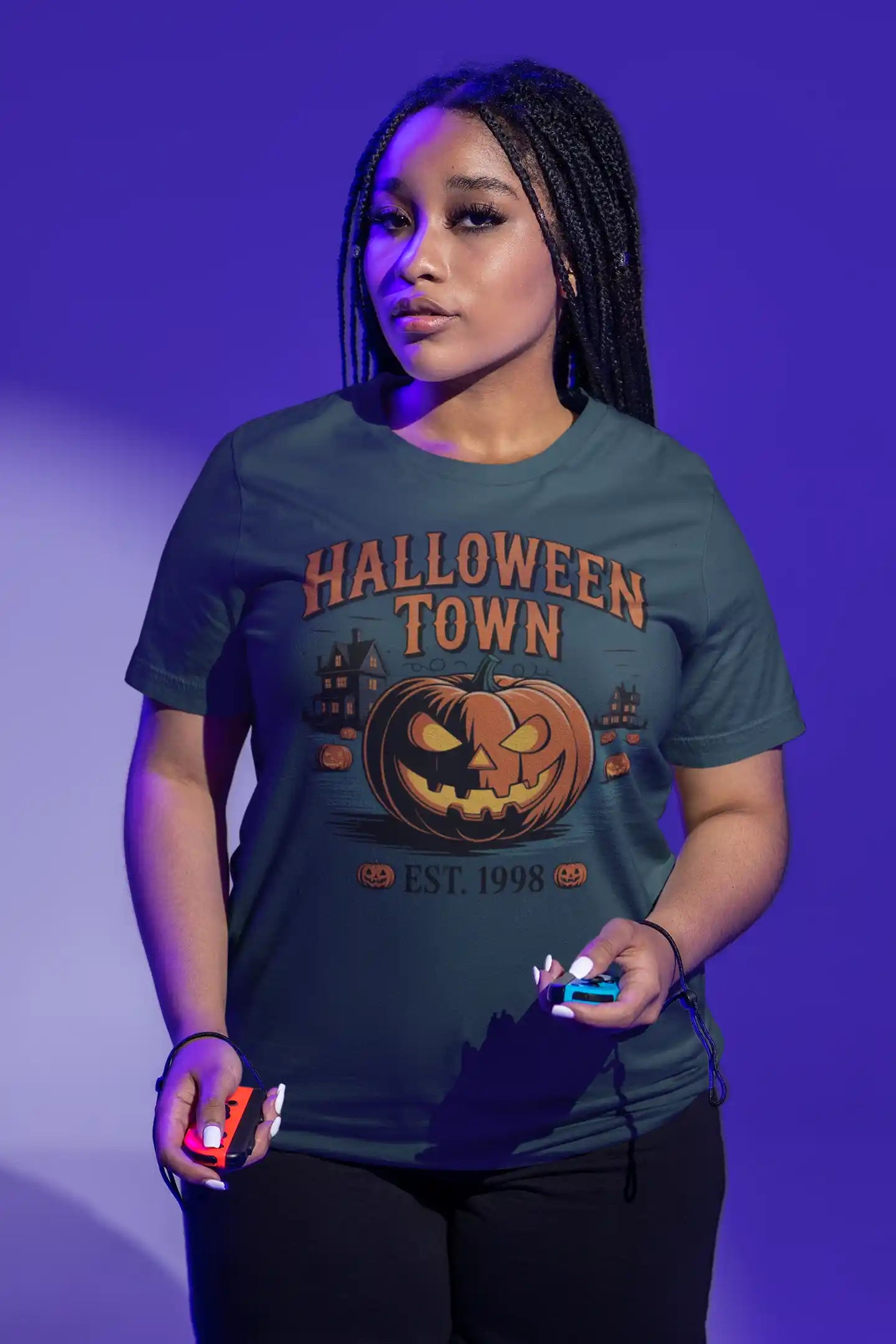 A woman wears a dark green Halloween Town t-shirt with a vintage pumpkin graphic.