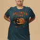 A woman wears a dark teal Halloween Town t-shirt with a vintage pumpkin graphic.