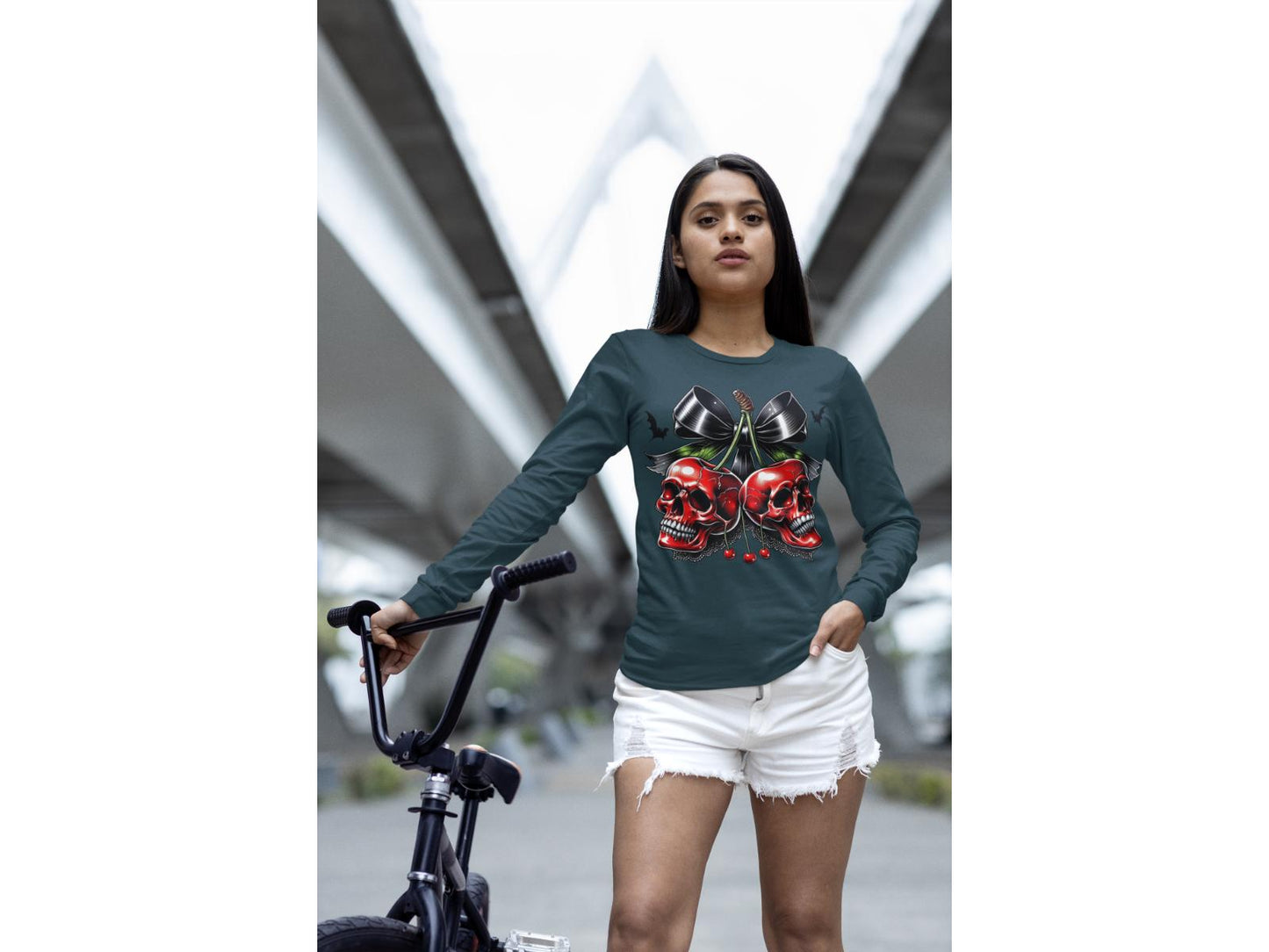 A woman wears a dark long-sleeve shirt with a spooky cherry and bow design.