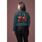 A woman from behind wears a dark teal long-sleeve shirt with a cherry skull design.